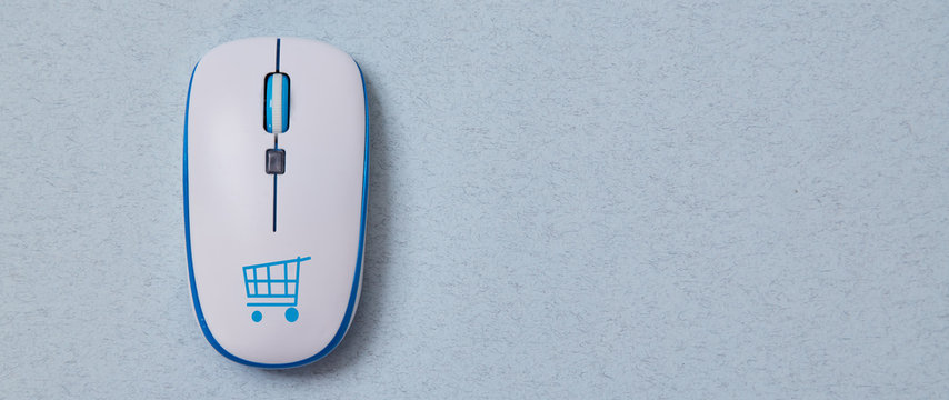 Online shopping, buying and e-commerce. Computer mouse with cymbol of basket. Blue background