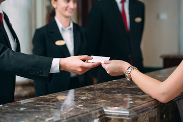 Picture of guests getting key card in hotel.