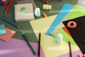 Bright colored paper, letters, stationery on the table, top view, background for inscriptions, back to school, education