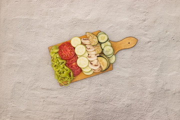 Fresh slices of organic vegetables on cutting board 