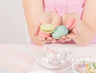 French colorful macaroons. Colorful pastel macaroons on white background. Pink and blue macaroons. Still life in pink and white