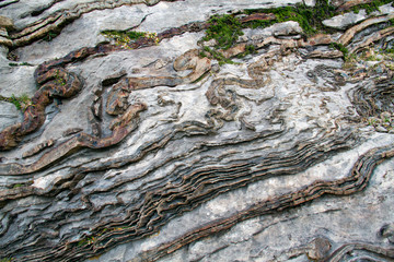 Deformed, curved layers in rock