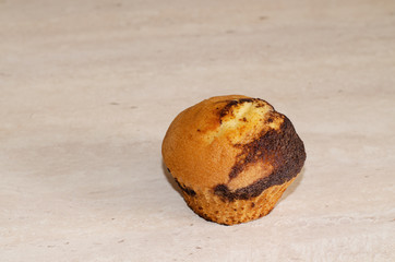 Cupcake with chocolate dousing on a wooden table. Free space, angle shot from above