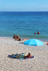 parasol and towels on the beach - Menton - French Riviera