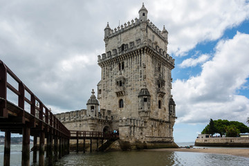 Belem Tower in Lisbon, Portugal with a blue cloudy sky