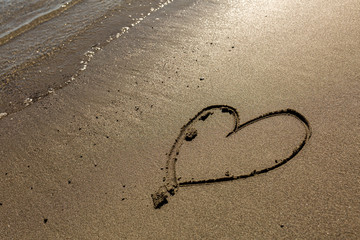 Hand drawn heart in the sand along the Mendocino coast