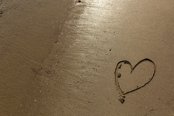 Hand drawn heart in the sand along the Mendocino coast