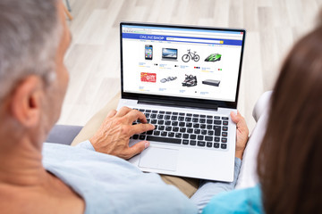 Fototapeta na wymiar Couple Using Laptop For Shopping Online