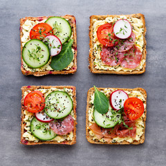 Sandwiches with cream cheese, vegetables and salami.