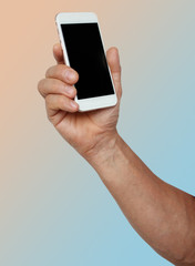 male muscular hand holds a smartphone, concept, horizontal, close-up, copy space