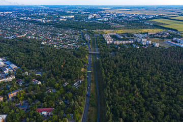 Aerial view of the suburbs with the city. Roads and railway.