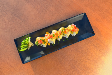 Vegetarian sushi roll with mango, cucumber, parsley.