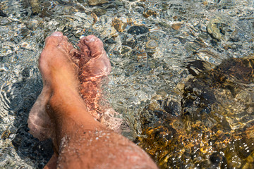 Relaxing feet in the sea