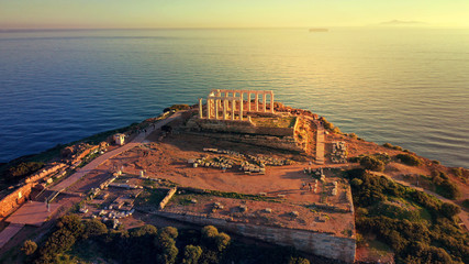 Aerial drone photo of sunset over the iconic Temple of Poseidon at Cape Sounio with amazing golden...