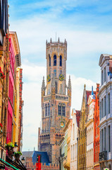 Naklejka premium The Belfry Tower (aka Belfort) and traditional narrow streets in Bruges (Brugge), Belgium