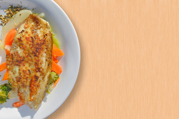 Tasty tilapia with vegetables as a side.