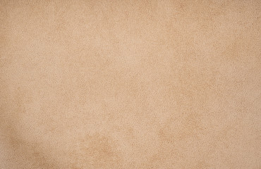 Fototapeta na wymiar Fluffy leather clothes detail. Sandy color background. 