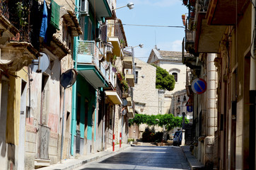 Fototapeta na wymiar Narrow urban street of Sicily,Comiso. Routine atmosphere,photo