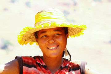 African woman repairing the roof in malagasy village, Madagascar