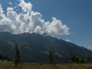 Beautiful green mountains and clouds in the resort of Rosa Khutor