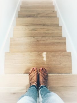 Woman standing at the top of a staircase