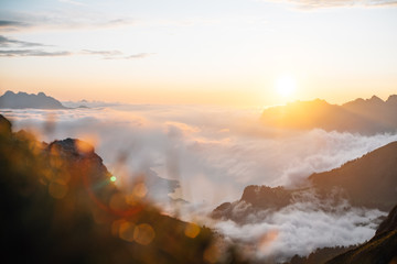 sunset in the mountains with a lake (walensee) under the clouds sea
