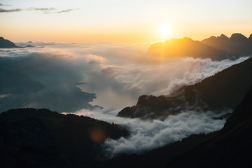 a mountain lake (walensee) in the light of the golden hour with sun flair