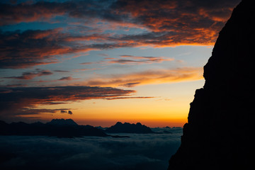 sea of clouds in the sunset with mountain ridge in the foreground