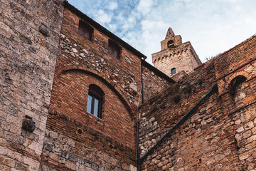 Fototapeta na wymiar Bottom view of castle walls, ancient city, San Gimignano, Italy