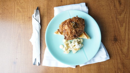 chicken and waffles on plate with fork and knife