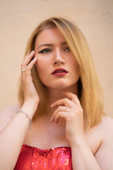 Naklejka premium blonde girl with wide make up arrows on the eyes posing in the street