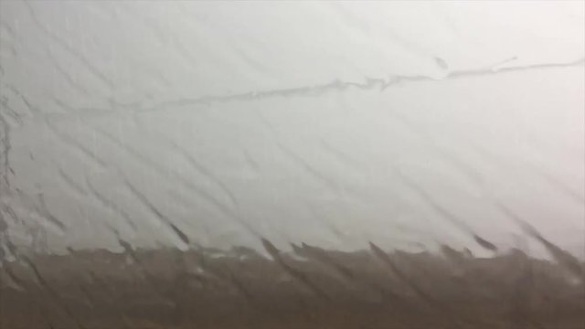 image of rain through the window of a car