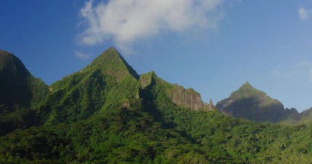 Aerial drone shot orbiting epic green island mountain peaks, island jungle landscapes