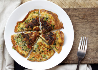 omelette on wooden background view from above