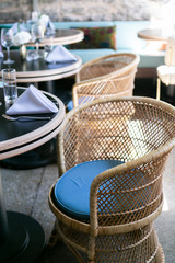 Rattan chair in front of table at restaurant, modern restaurant furniture