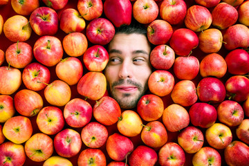 Man with apples, concept for the food industry. Face of man in the apfel surface. No plastic concept. Packaging