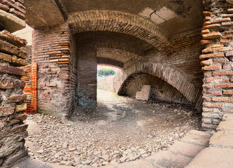 Archaeological excavations street view of ancient Roman ruin with vaults and pathways surrounded by brick walls