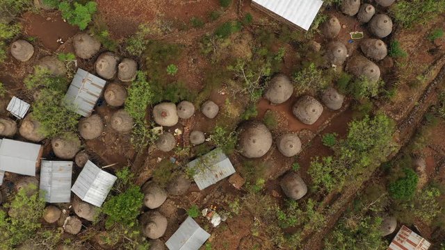 Ascending drone shot of classic village with gardens and homes (huts) made of straw in Konso, Ethiopia