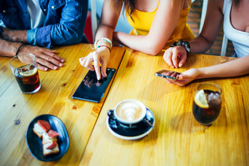 Three young friends having fun in restaurant