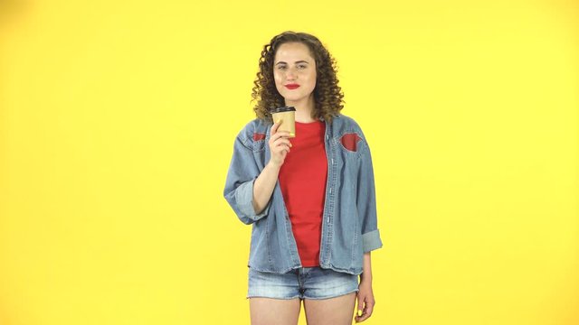 Girl drinks aromatic coffee and then feels an aversion to taste.