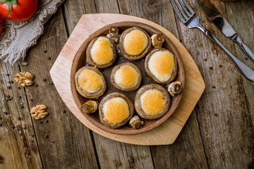 mushrooms baked with Suluguni cheese on wooden table, Georgian kitchen