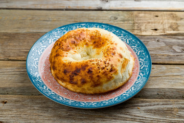Uzbek bread from tandoor on old wooden table