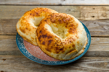 Uzbek bread from tandoor on old wooden table