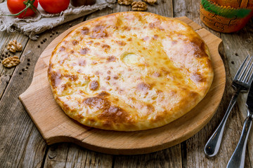 khachapuri with cheese on wooden table. Georgian cuisine