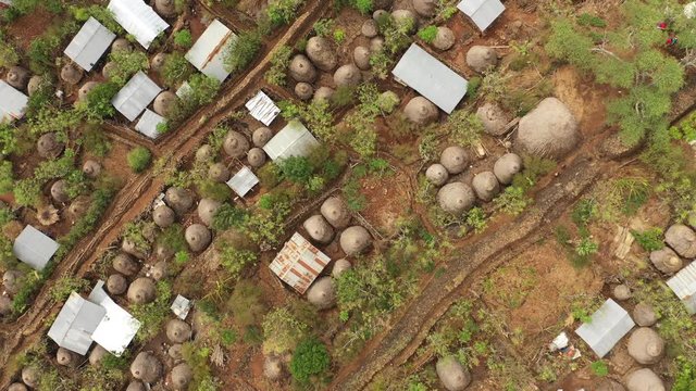 Flying over traditional village with classic homes and gardens in Konso, a tribal community in South Ethiopia
