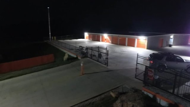 Aerial of car entering self-storage facility at night