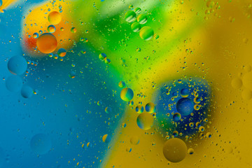 Micro molecular abstract pattern of colored oil bubbles on water. 