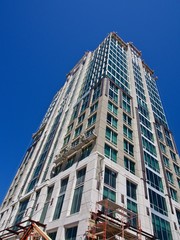 Fototapeta na wymiar Skyscraper Under Construction up against a Blue Sky