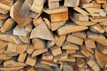 pile of seasoned different sized slab wood