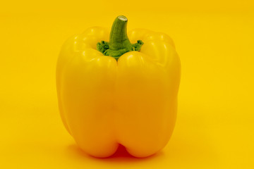 Yellow, sweet bell pepper on yellow background.